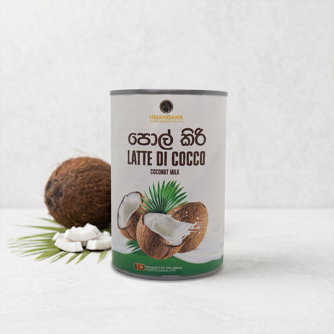 Can of coconut milk with coconuts and coconut pieces on a white background